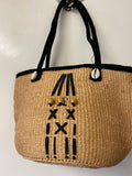 Kenyan sisal kiondo with a short leather handle. Beads and leather strips at the front.