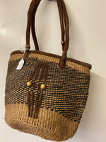 Kenyan sisal kiondo with a short leather handle. Beads and leather strips at the front.