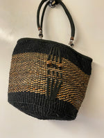 Kenyan sisal kiondo with a short leather handle. Beads and leather strips at the front.