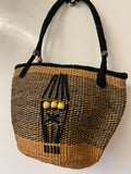 Kenyan sisal kiondo with a short leather handle. Beads and leather strips at the front.